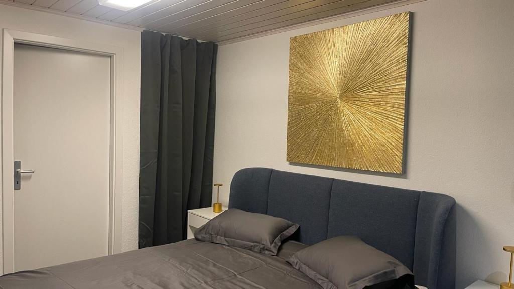 日内瓦La Croisette SA的卧室配有一张床,墙上挂有绘画作品