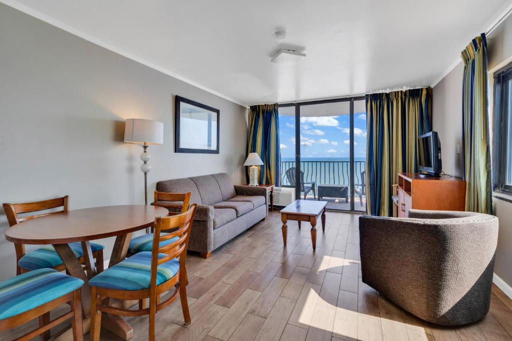 默特尔比奇Beachfront Luxury Condo w Private Balcony的带沙发和桌子的客厅以及用餐室