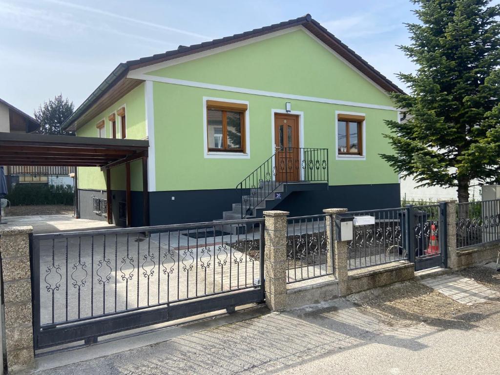维也纳AJO Vienna Ambassador Family House with Free Parking的一座带围栏的小绿色房子