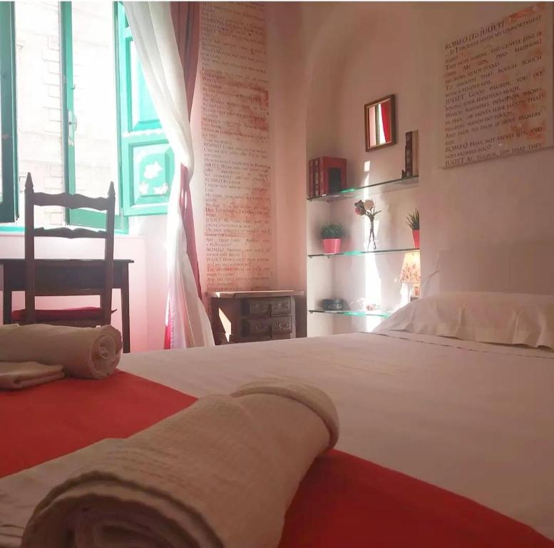 安科纳B&B La Casa in Centro的卧室配有一张大白色的床和桌子
