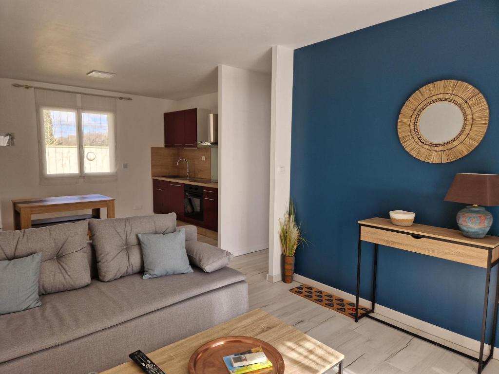 吕内尔Chez Valéric的带沙发和蓝色墙壁的客厅