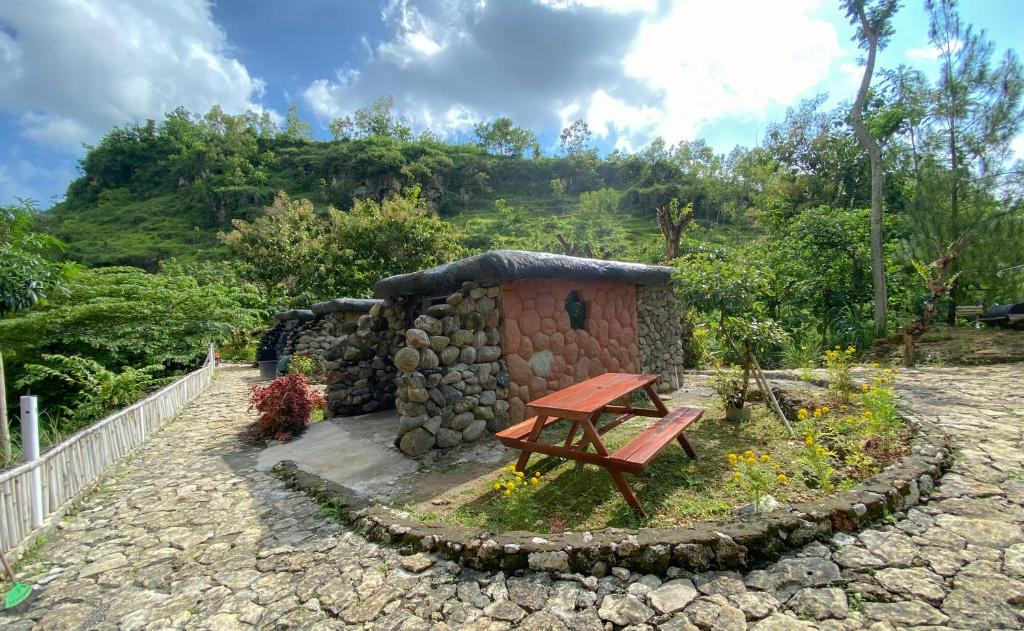 KarangwetanPALEO Stone Age的花园内带野餐桌的小建筑