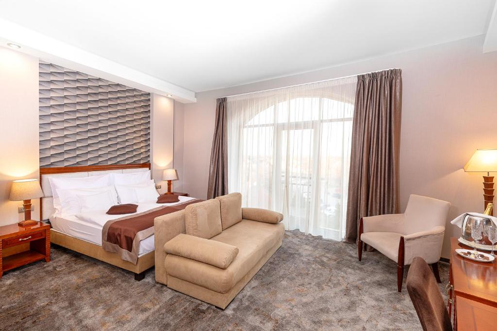 莫劳豪洛姆斗兽场酒店的酒店的客房 - 带一张床、椅子和窗户
