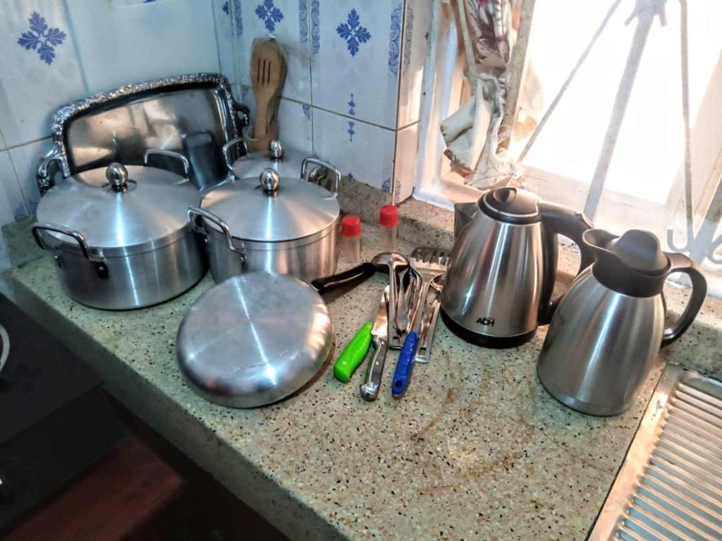 卡巴莱Kabale town flat的坐在厨房柜台上的三锅锅碗瓢盆