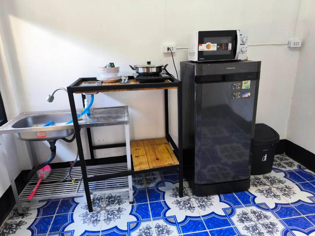 清刊บ้านพักเหมาหลังเชียงคาน ฮักเลย ฮักกัญ โฮมสเตย์ 2- ຊຽງຄານ ຮັກເລີຍ ຮັກກັນ ໂຮມສະເຕ2 -Chiang Khan Hugloei HugKan Homestay2的一间带微波炉和冰箱的小厨房