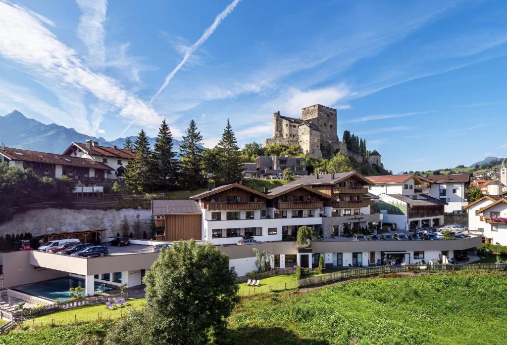 拉迪斯Alpin Chalet am Burgsee的山顶上带城堡的度假胜地