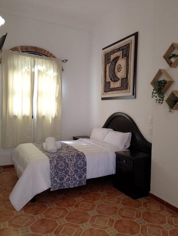 普埃布拉CASONA ALBARELO的一间卧室设有两张床和窗户。