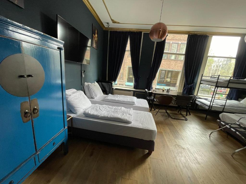 阿姆斯特丹Amsterdam Rembrandt Square city center Hotel的有两张床和一张桌子的房间