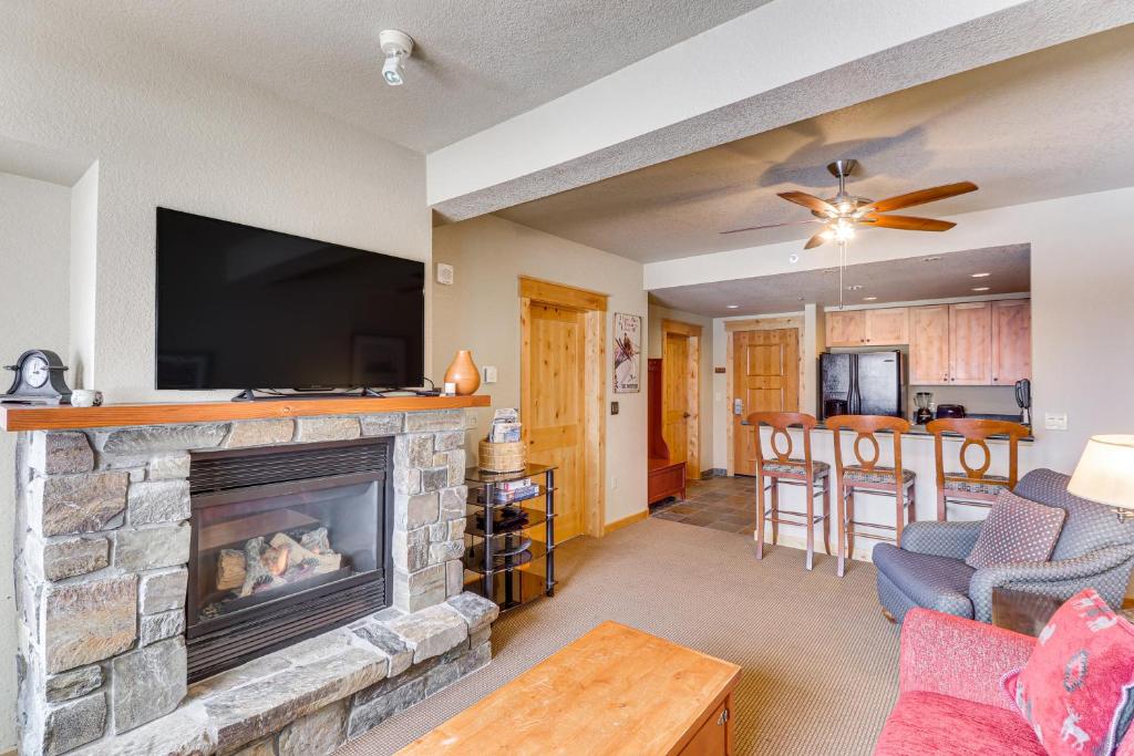 白鱼镇Whitefish Mountain Condo - Ski Resort On-Site!的客厅设有壁炉和平面电视。