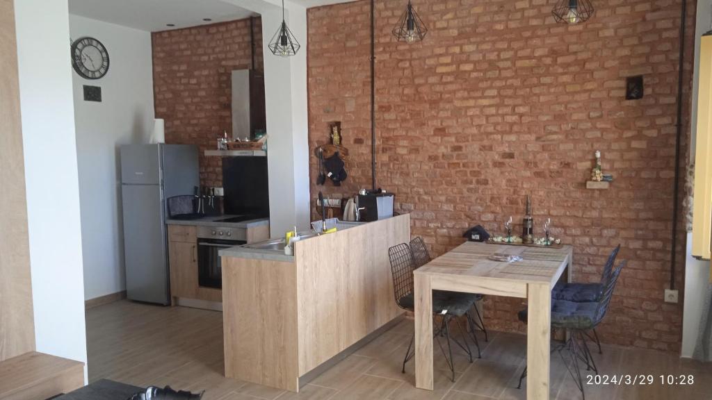 马拉希亚斯HARI'S NEST CORFU的厨房配有桌子和砖墙