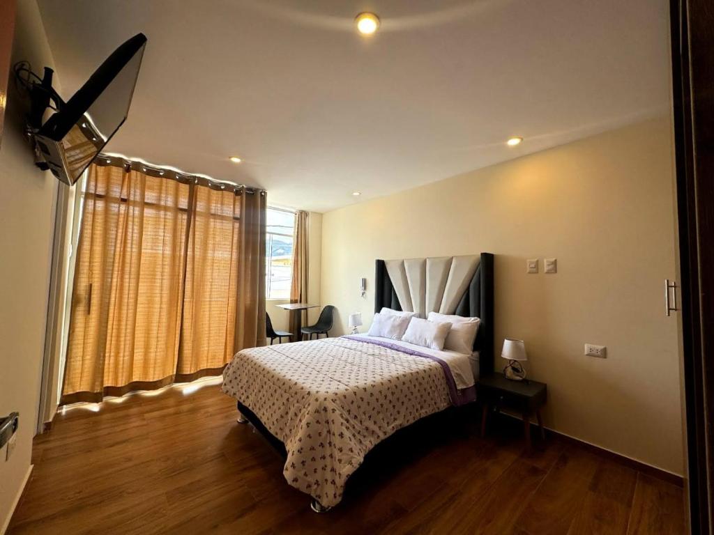 卡哈马卡Las Condes II的一间卧室设有一张床和一个大窗户