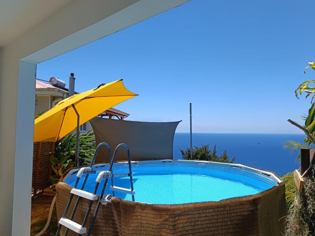 舍尔谢Poz Tropicale的一个带遮阳伞和椅子及桌子的游泳池