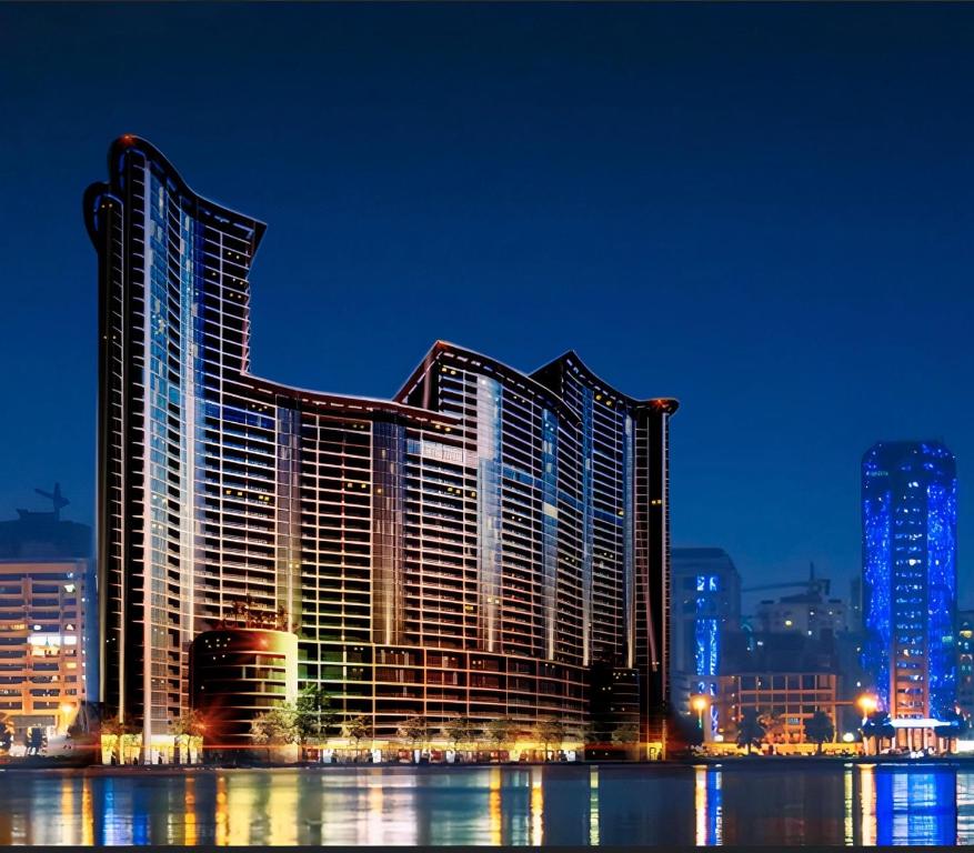 阿吉曼CMA Skyline Sanctuary Apartments - Ajman Corniche UAE的一座在晚上有灯的大建筑