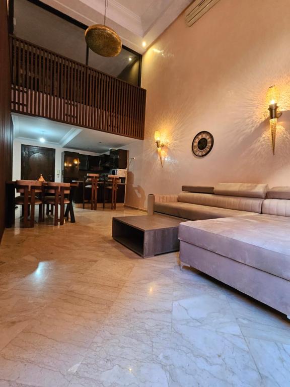 马拉喀什Charmant duplex au cœur de gueliz, quartier haut de gamme de Marrakech的客厅配有沙发和桌子