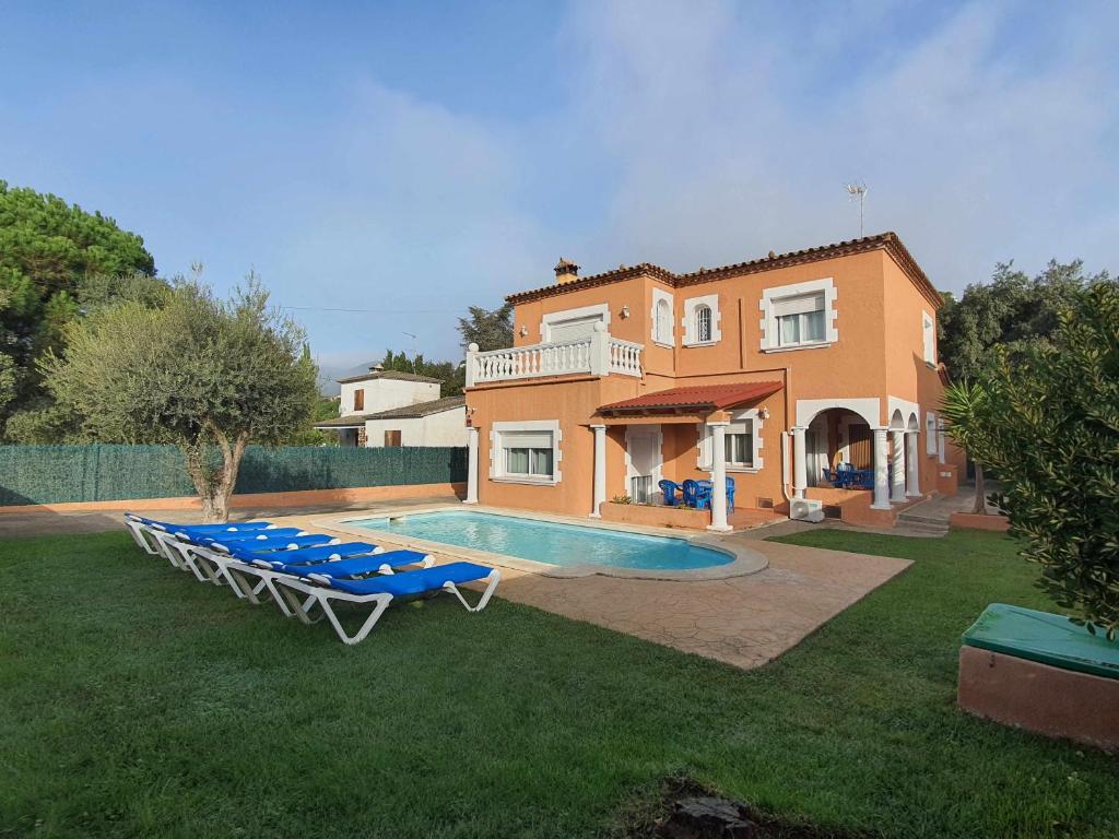 卡隆赫Costa Brava Suites Villa Cèsar的一座带游泳池和房子的别墅