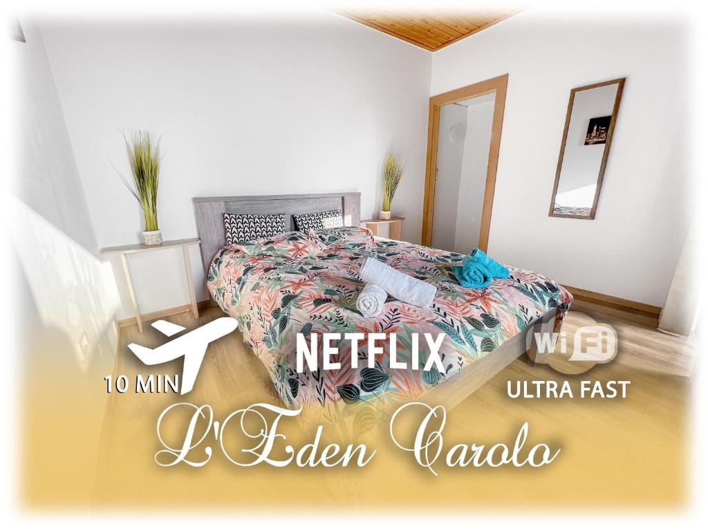 DampremyL'Eden Carolo - Netflix, Wi-Fi, 10min Aéroport, Parking gratuit的一间卧室配有一张带笔记本电脑的床