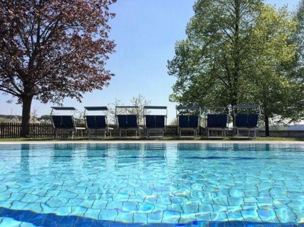 巴德瓦尔特斯多夫Ferienhaus in Wagerberg mit Garten, Terrasse und Whirlpool的一个带蓝色椅子的游泳池