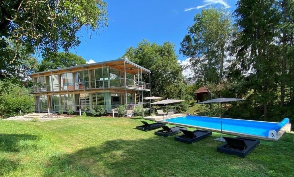 多瑙艾辛根Sportives Ökologisches Lifestyle-Ferienhaus mit großem Außenpool, Sauna und Fitnessbereich的一座大房子,在庭院里设有一个游泳池
