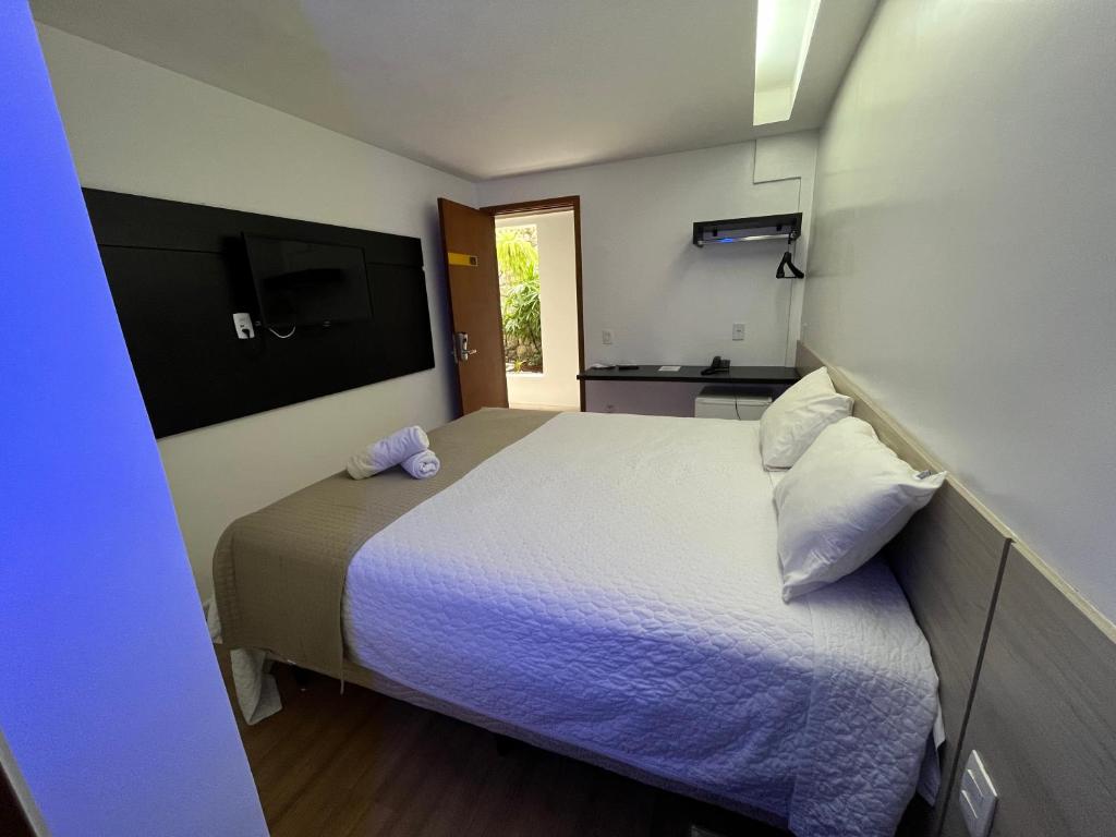 马塞约Mcz Hotel的一间带床的小卧室和一间厨房