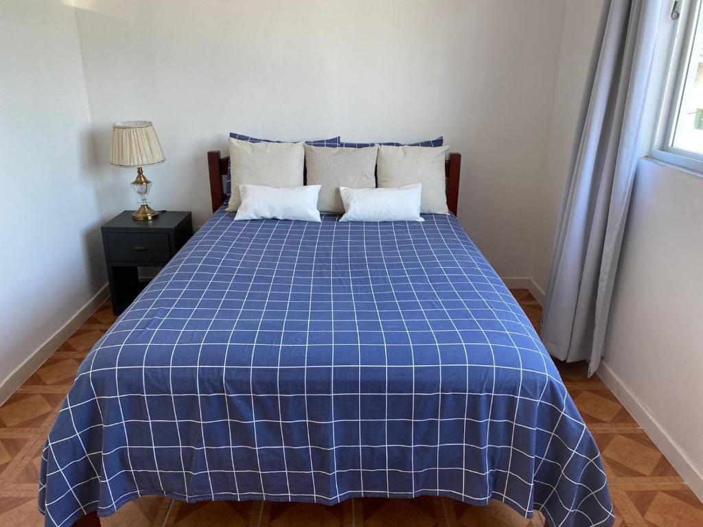 弗洛里亚诺波利斯Residencial Sullivan - Florianópolis - Loft 01的客房内的一张蓝色和白色的床