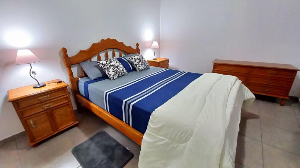 戈多伊克鲁斯Sueños Del Pilar II的一间卧室配有一张带蓝色和白色棉被的床