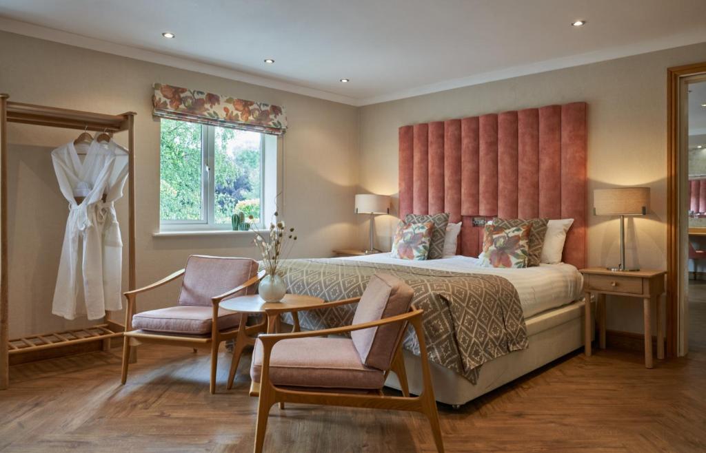 沃尔索尔菲尔劳温斯温泉酒店的卧室配有一张床和一张桌子及椅子