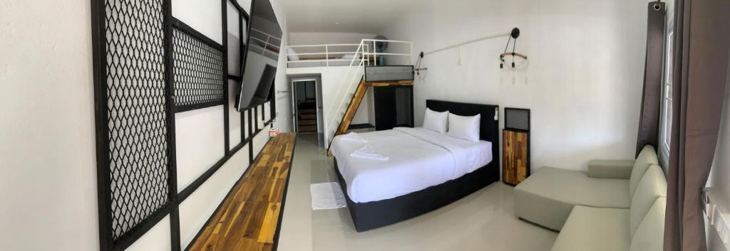 涛岛Amazing Inn Koh Tao的卧室配有白色的床和沙发