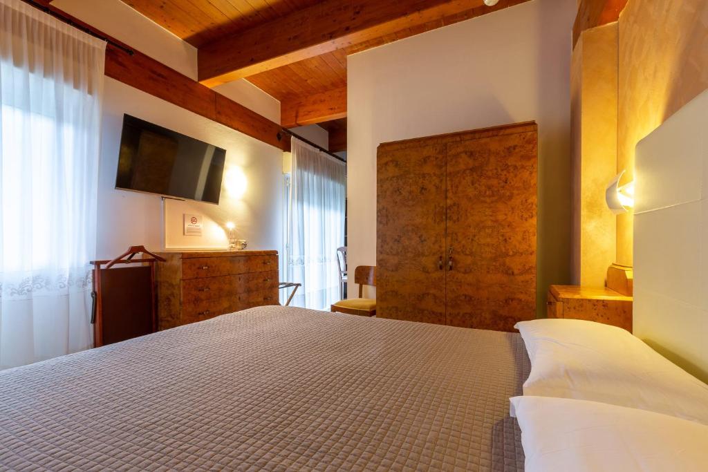 玛里纳罗米亚哥伦比亚酒店的卧室配有一张床,墙上配有电视。