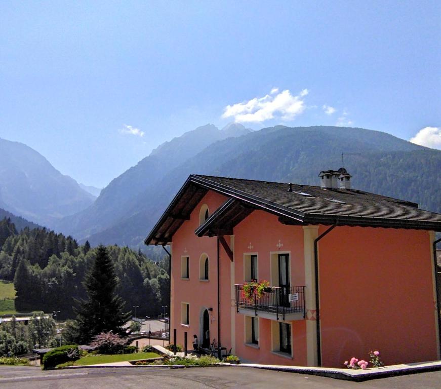 泰穆Appartamenti Flora Alpina的带阳台的大楼,享有山脉的背景