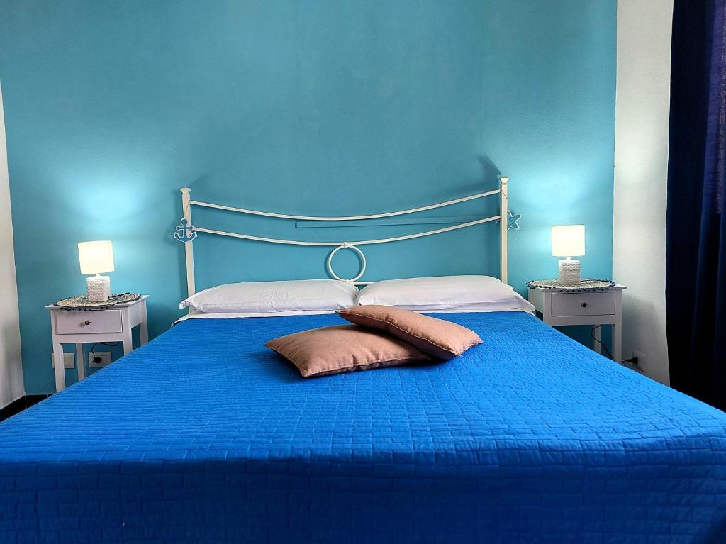 蓬扎La casa dei 4 venti的蓝色卧室配有蓝色的床和2个枕头