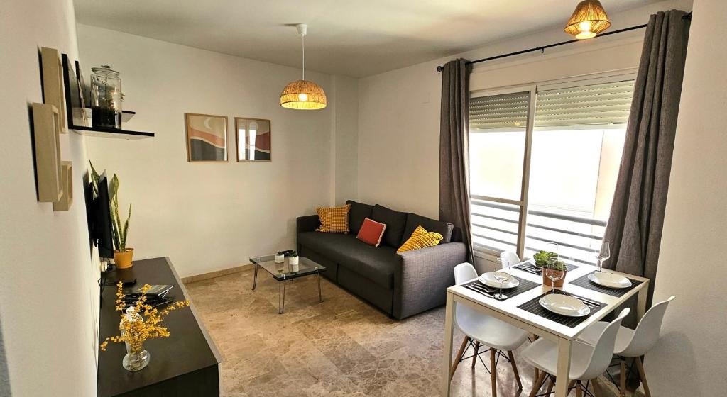 马拉加Romántico apartamento céntrico的客厅配有沙发和桌子