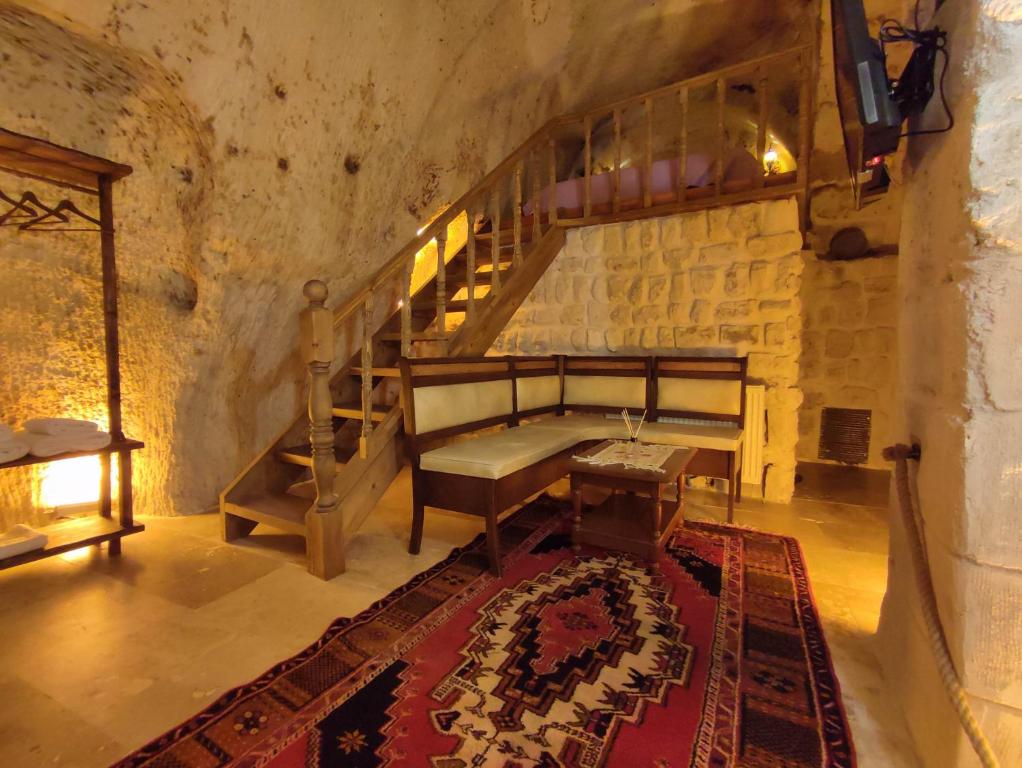 NarEuphoria Cave House的一间设有楼梯、长凳和地毯的房间