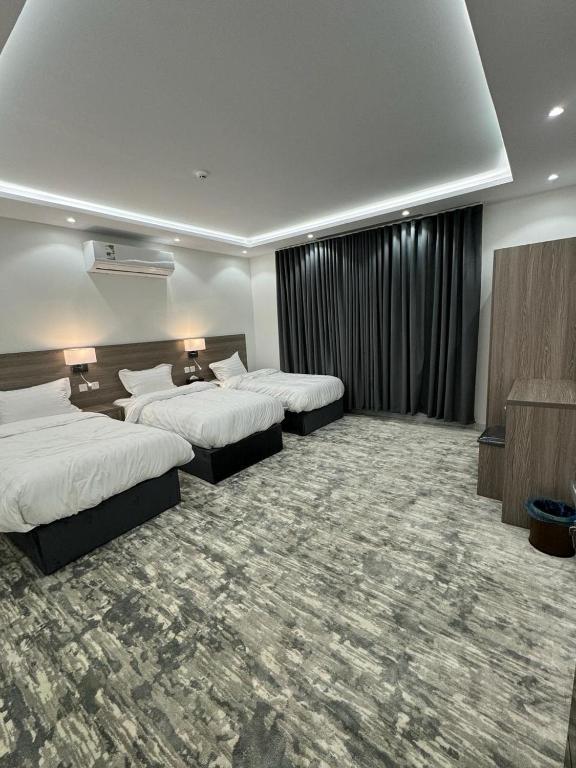 Sīdī Ḩamzahتوبال الماسي的酒店客房设有两张床和电视。