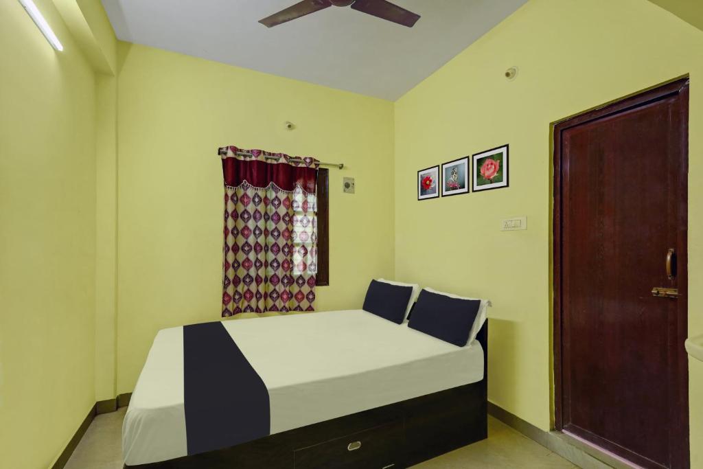 ChittoorSPOT ON SV Lakshmi Residency的一间卧室设有一张床和一个窗口