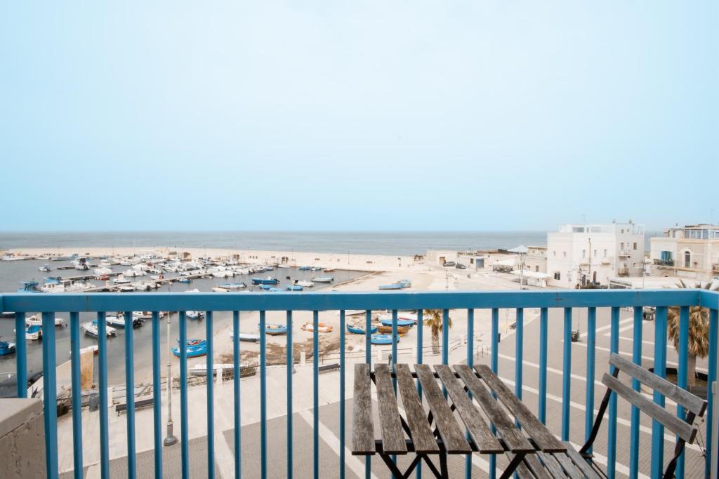 托雷阿马莱Three Room - Sea View Luxury Loft的俯瞰码头的阳台的长凳