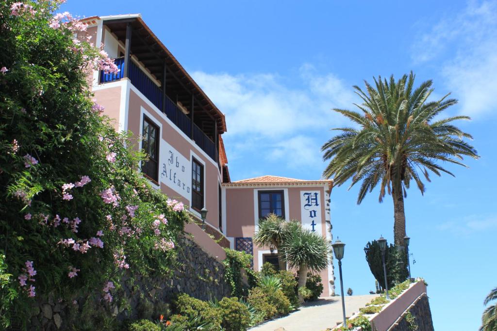 埃尔米瓜Hotel Rural Ibo Alfaro - OFFLINE HOTEL的前面有棕榈树的房子