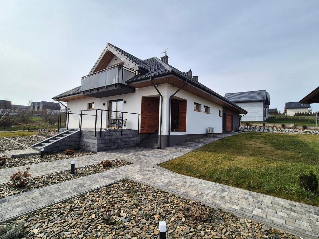 弗瓦迪斯瓦沃沃Wypoczynek nad zatoką Apartamenty Władysławowo的黑色屋顶的白色房子