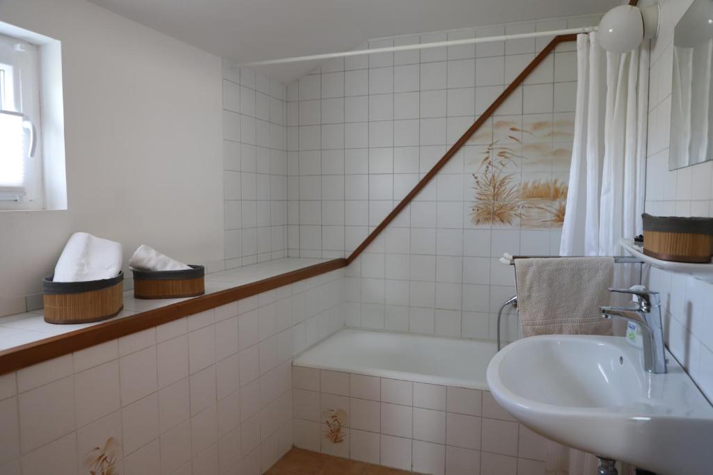 巴拉顿博格拉尔Attila Vendégház的浴室配有盥洗盆和浴缸。