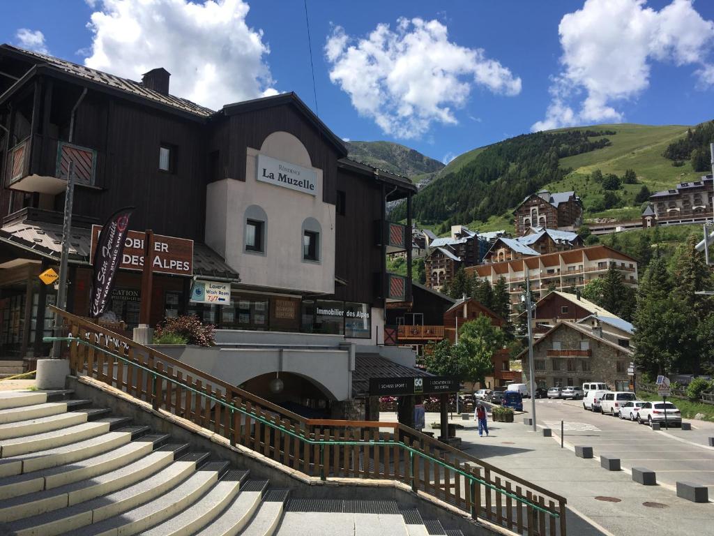 莱德萨阿尔卑斯travelski home classic - Résidence La Muzelle的山中一座拥有建筑和楼梯的小镇