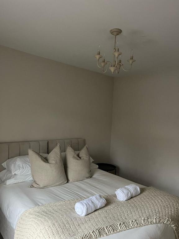 沃特福德Rickmansworth Lodge的一间卧室配有一张床,上面有两条毛巾
