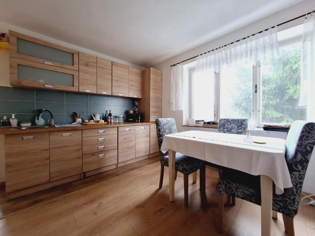 HuniskyLesný domček的厨房配有桌椅和窗户。