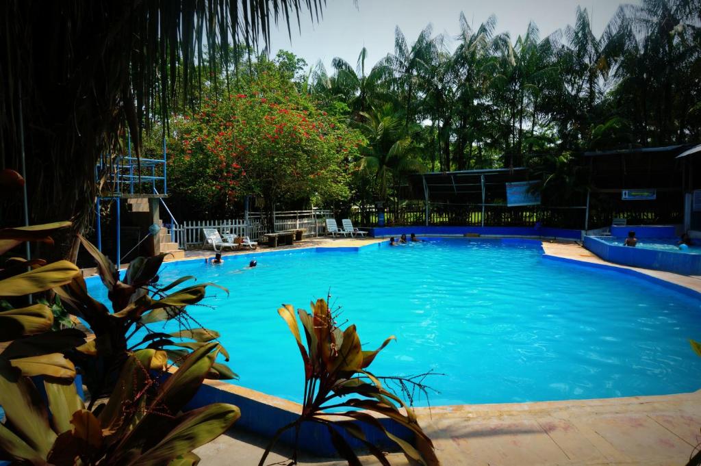 马尔多纳多港Villa Hermosa de Tambopata Casa Hospedaje & Hostel的一个大型蓝色游泳池,里面有人