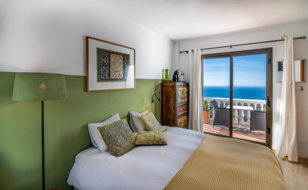 赛阿隆加Campo Agave B&B的一间卧室设有一张床,享有海景