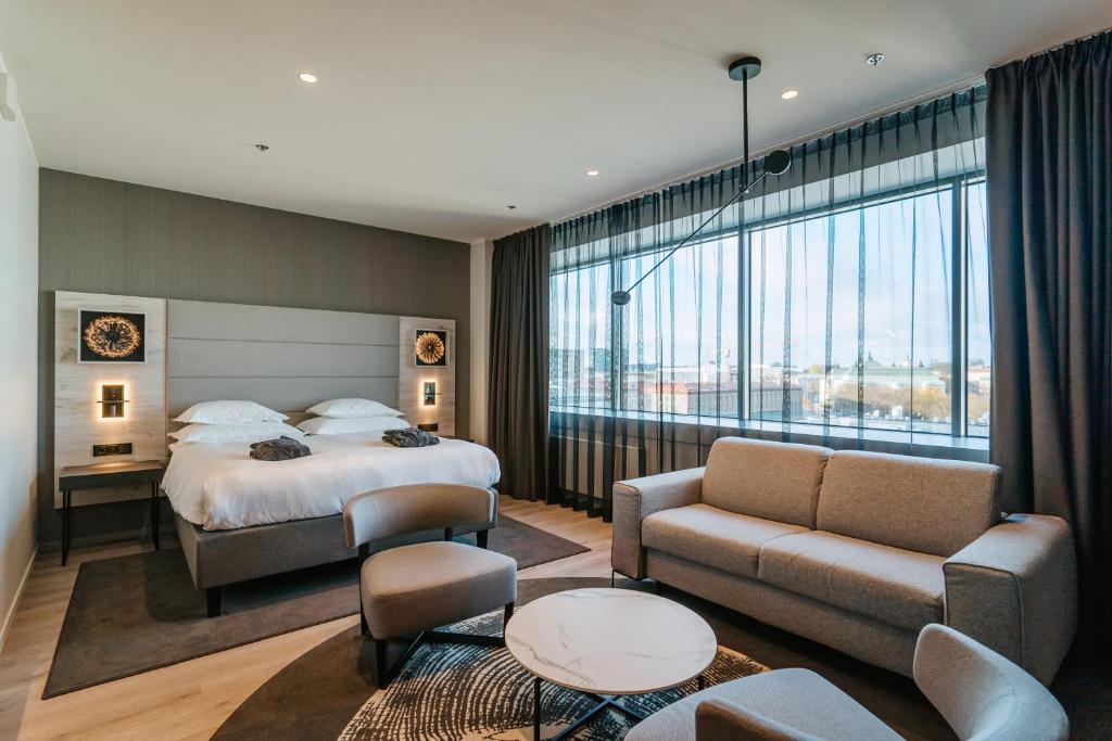 塔林塔林城市酒店的酒店客房设有一张床和一个大窗户