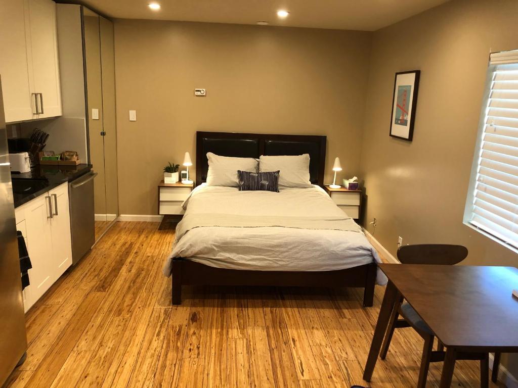 East Palo AltoModern studio within easy reach of Tech Giants的一间卧室设有一张大床,铺有木地板