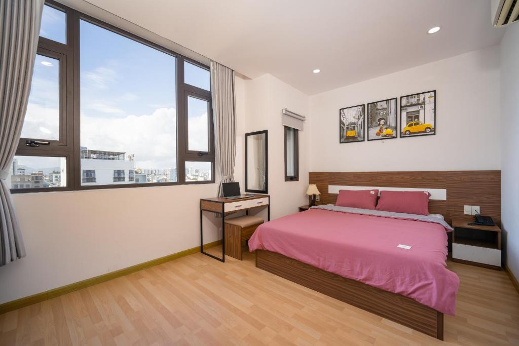 岘港S HOTEL BEACH ĐÀ NẴNG的一间卧室设有一张床和一个大窗户