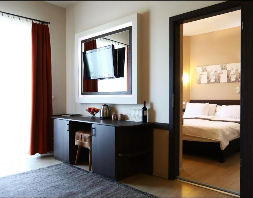 希欧福克里瓦酒店的一间卧室配有一张带镜子的床和一张书桌