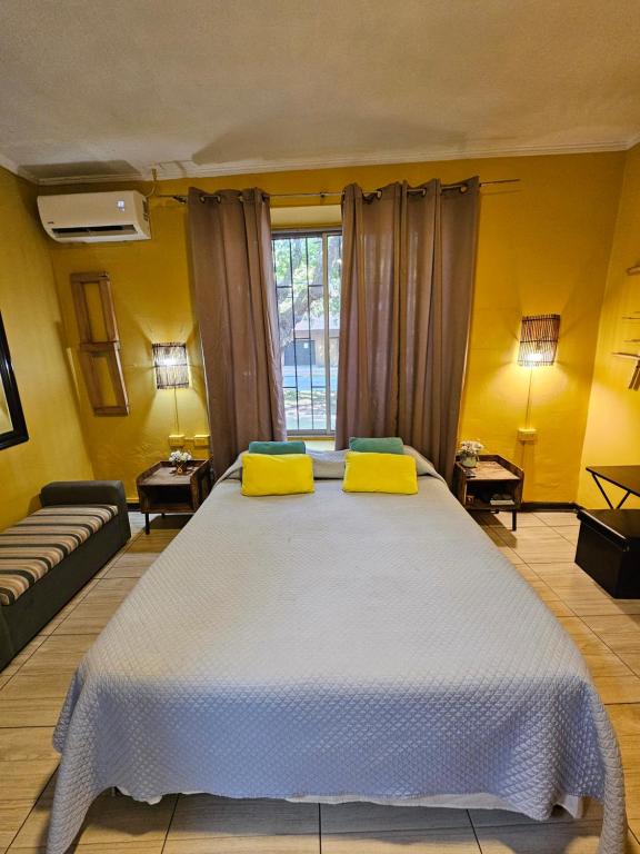 莫利纳Hostal Pucara Molina的一间卧室设有一张黄色墙壁的大床