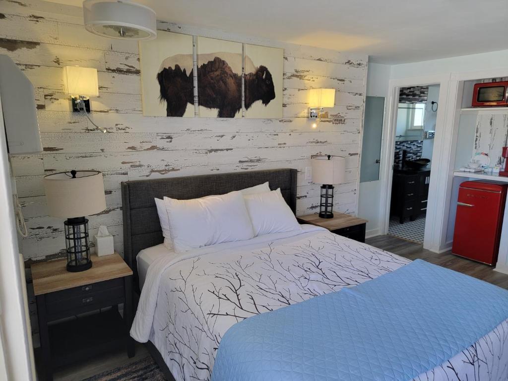 萨利达银岭小屋酒店的一间卧室配有一张床和两张带台灯的桌子。