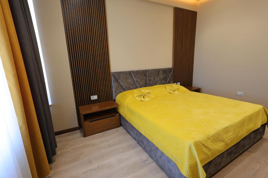 培拉特Rezidenca Arlington的一间卧室配有一张黄色毯子床